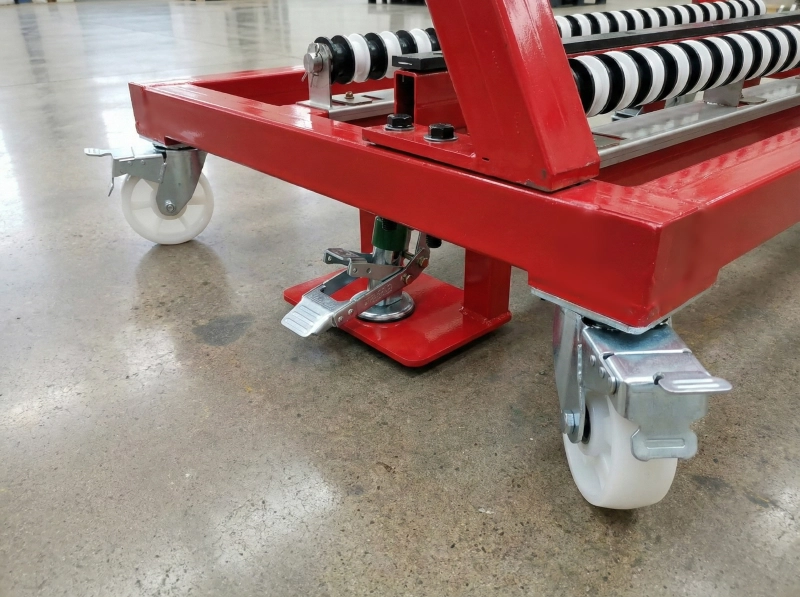 The foot-actuated locking mechanism on the mold storage racks, ensuring safe transport of heavy tooling.