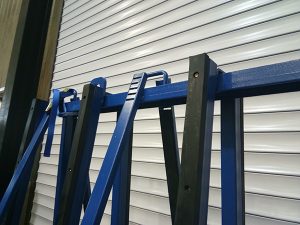Does an a frame storage rack prevent scratches on security glass partitions?